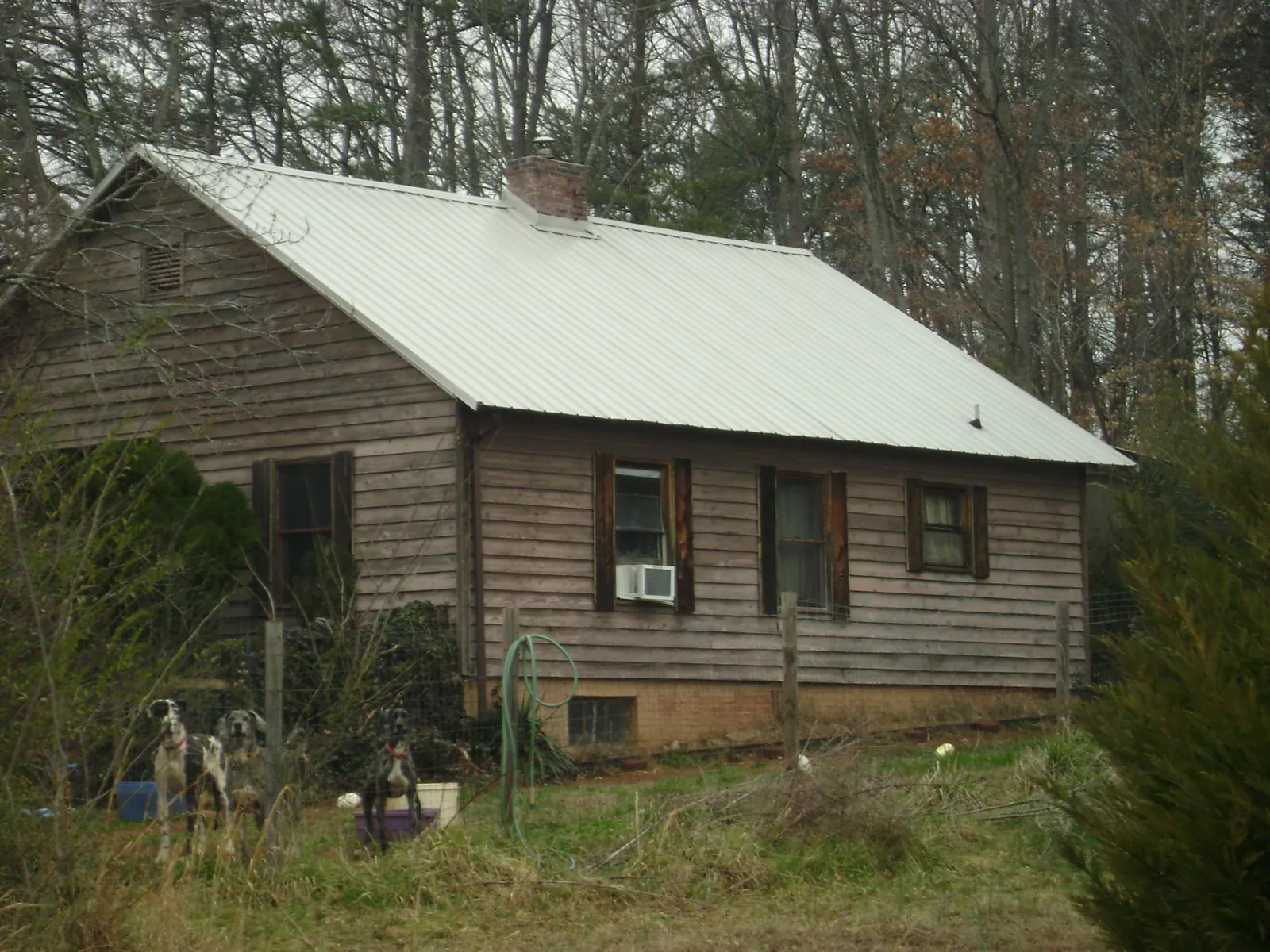 White metal roof on an old wood sided farmhouse, from a Metal Roof Installation job in Winnsboro